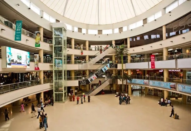The domed atrium of Avenue Food Mall on 200 Feet Radial Road, Chennai, ringed by upper-floor storefronts around a central escalator well