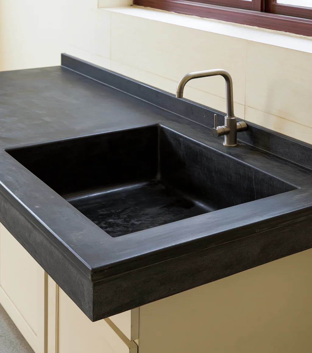 Kitchen sink counter carved from a single slab of black Kadappa stone
