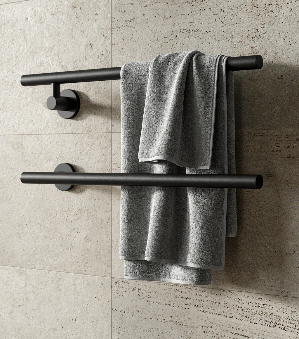 Matte black double towel bar with grey towels, against a stone-textured wall