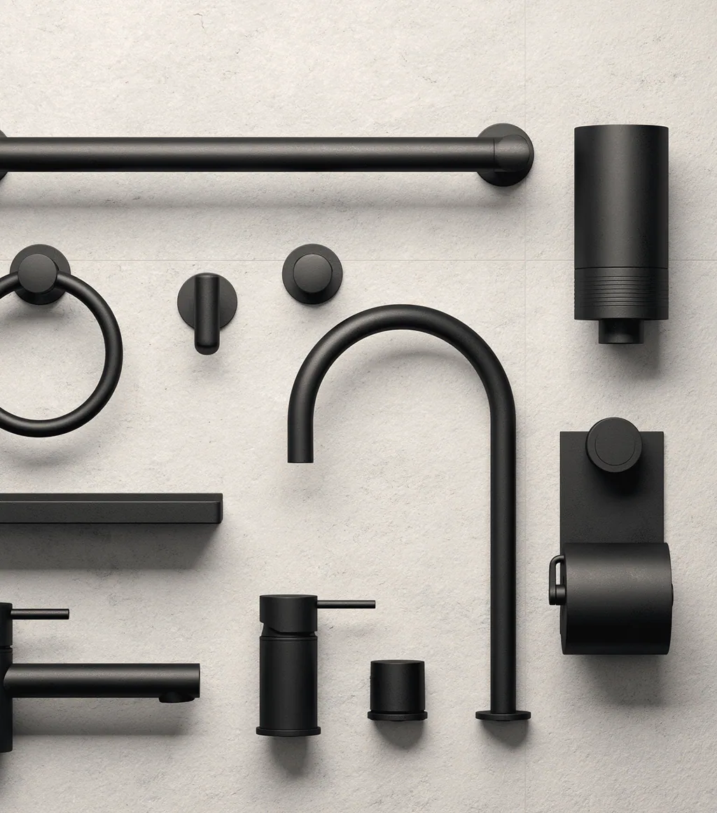 Matte black accessory set laid out: towel bar, ring, hooks, basin mixer, soap dispenser, toilet-roll holder and tumbler