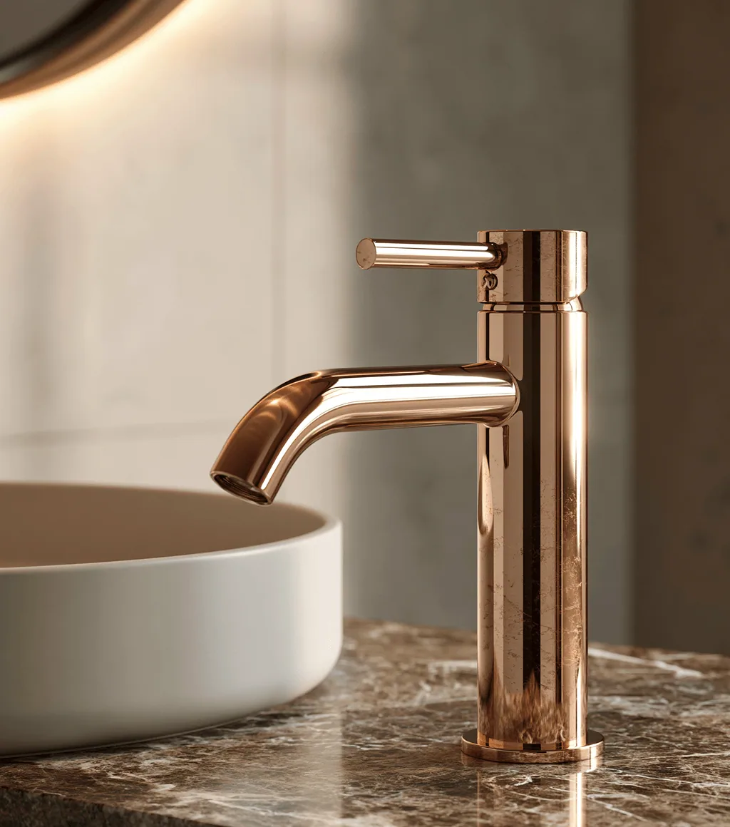 Rose-gold basin faucet paired with a round white vessel basin on a brown marble counter