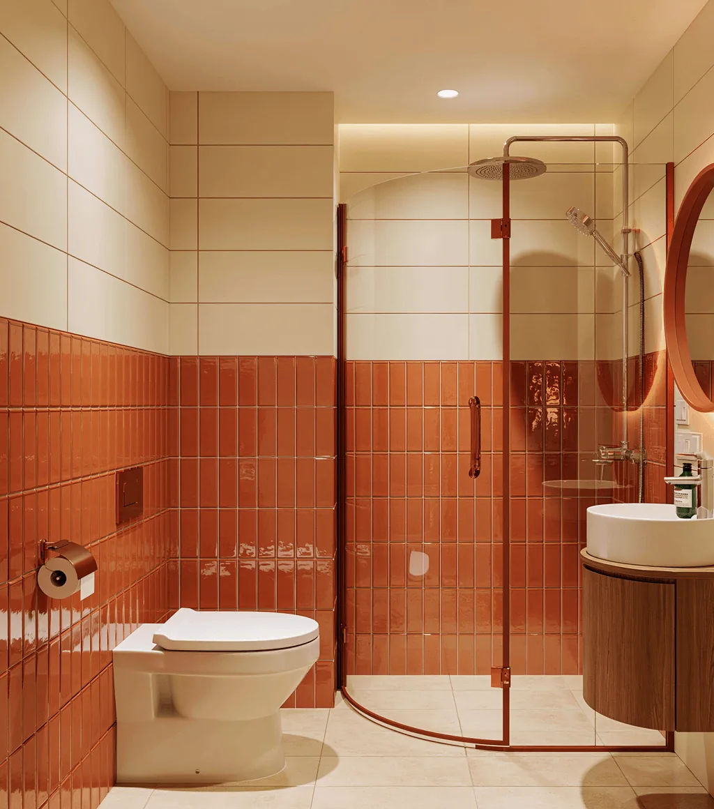 Bathroom with a terracotta-and-cream two-tone brick-bond wall tile, beside a curved glass shower screen