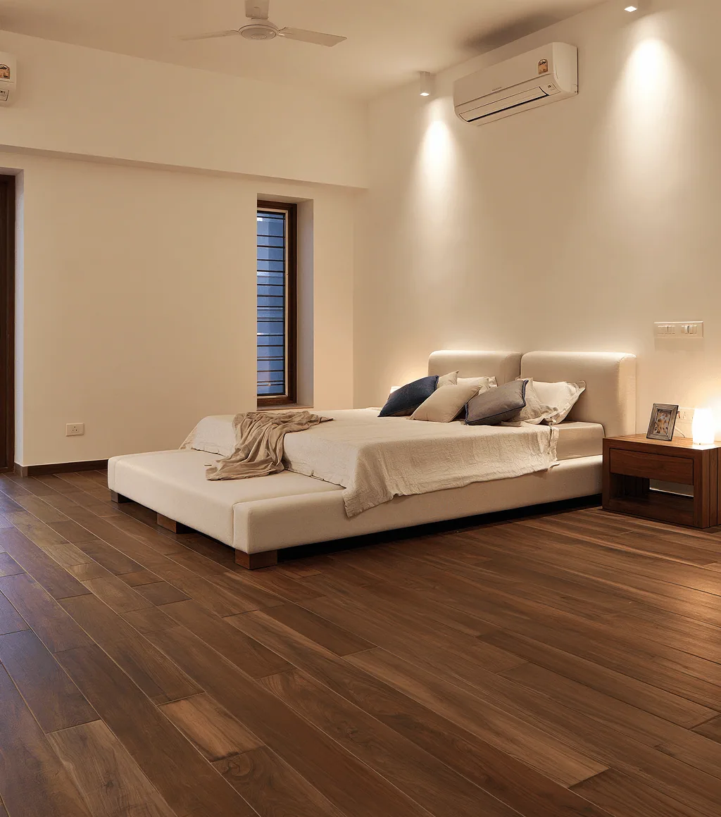 Bedroom floor in dark walnut wood-look plank tile, beside a minimalist white bed