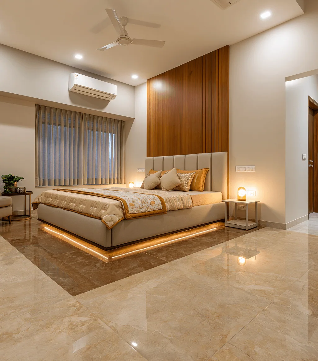 Bedroom floor in glossy warm beige-brown marble-look tile, beside a backlit bed platform and wood-panelled headboard wall