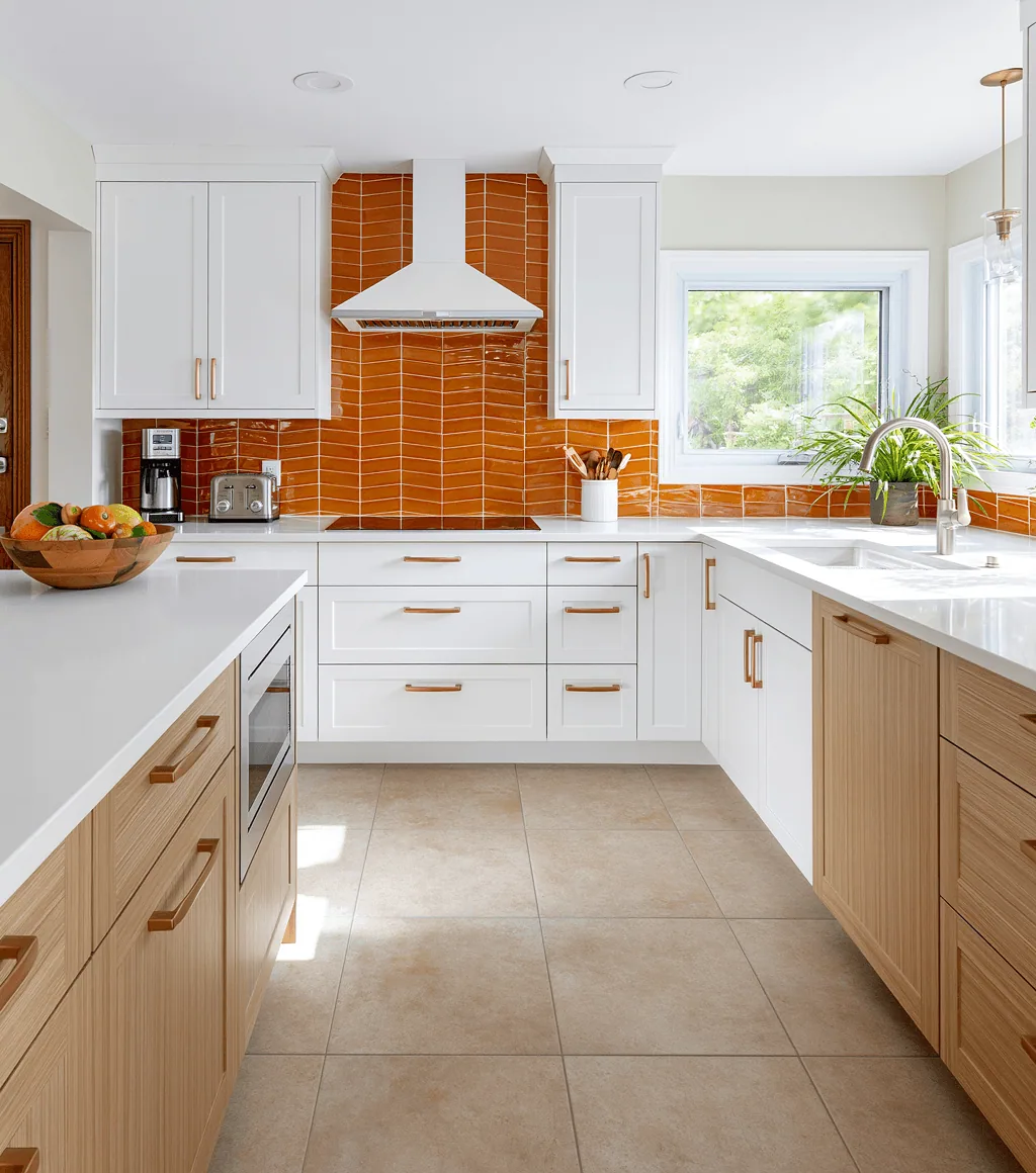 Kitchen with warm beige large-format floor tile and a burnt-orange chevron-pattern backsplash
