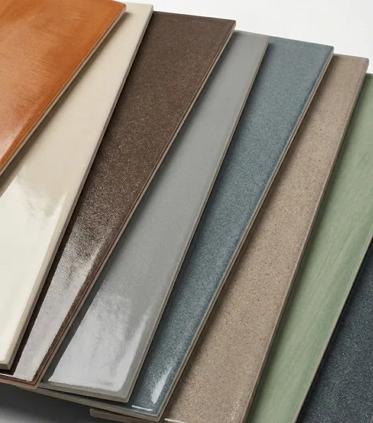 Stack of glazed tile sample planks in orange, cream, brown, grey, teal and green finishes